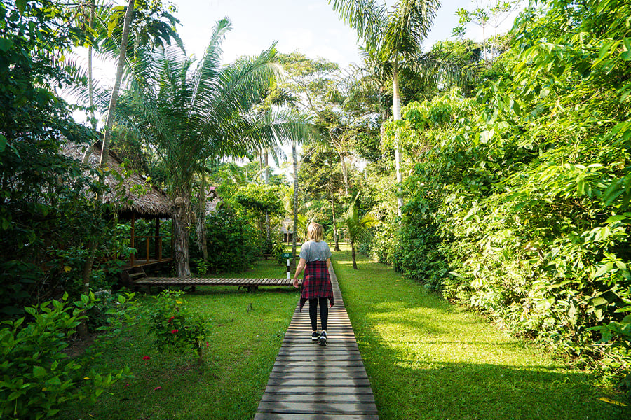 Woman walking on pathway in tropical destination