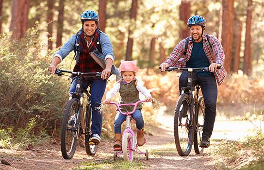 Family biking on a path during summer