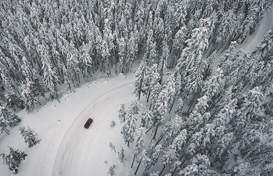 How to Drive in Winter - car on a snow-covered forest road