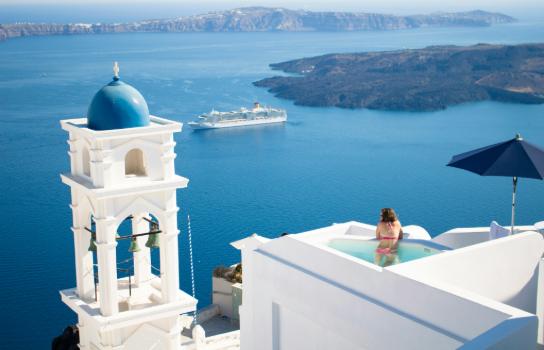 Woman in swim up pool in hotel in Greece